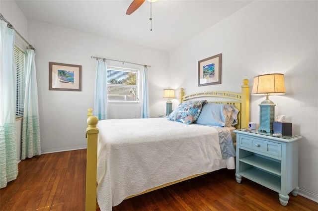 bedroom with ceiling fan, wood finished floors, and baseboards