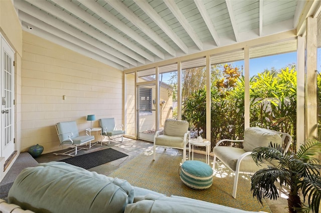 sunroom / solarium with vaulted ceiling with beams