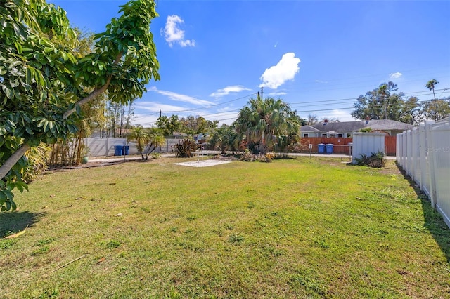 view of yard with an outbuilding and a fenced backyard