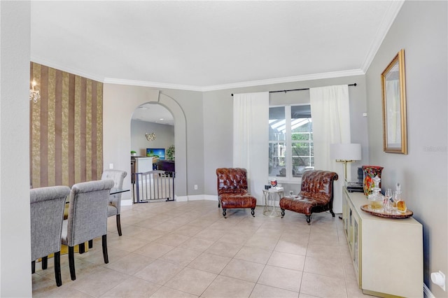 sitting room featuring light tile patterned floors, baseboards, arched walkways, and crown molding