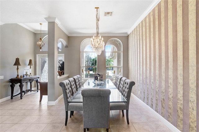 dining room with light tile patterned flooring, visible vents, baseboards, an inviting chandelier, and crown molding