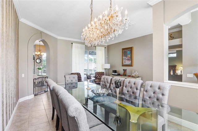 tiled dining room featuring baseboards, arched walkways, a chandelier, and crown molding