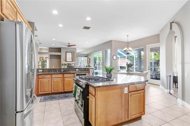 kitchen with light tile patterned floors, visible vents, stainless steel appliances, and a sink