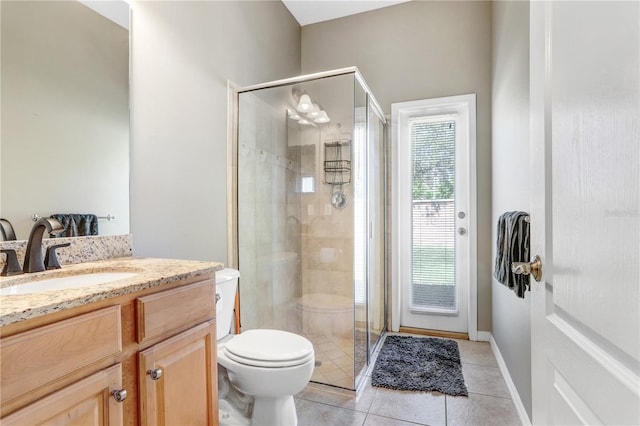 full bath with toilet, a shower stall, vanity, tile patterned flooring, and baseboards