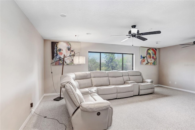 living room featuring light carpet, a textured ceiling, a ceiling fan, and baseboards