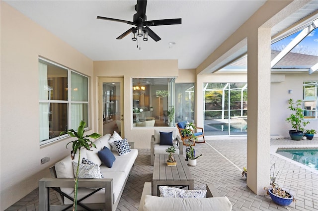 view of patio featuring an outdoor pool, glass enclosure, ceiling fan, and outdoor lounge area