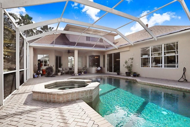 exterior space with a ceiling fan, a patio, a lanai, a pool with connected hot tub, and stucco siding