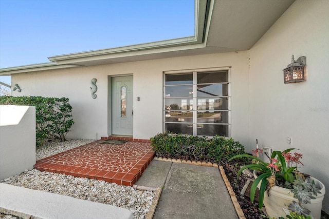 property entrance featuring stucco siding