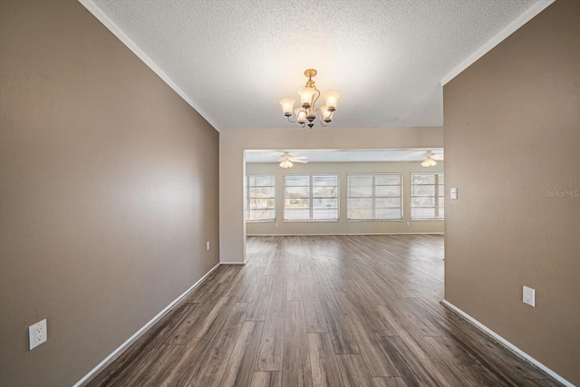 interior space with ceiling fan with notable chandelier, dark wood-type flooring, and a textured ceiling