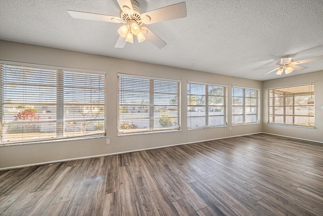 unfurnished sunroom with a ceiling fan