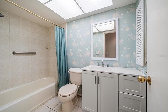 full bathroom with toilet, a skylight, vanity, tile patterned floors, and wallpapered walls