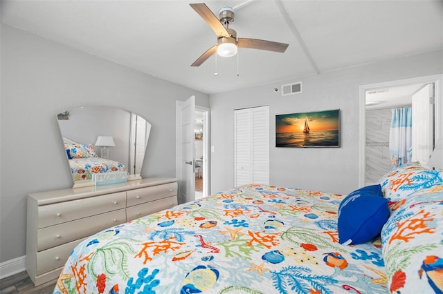 bedroom with visible vents, ceiling fan, wood finished floors, ensuite bathroom, and a closet