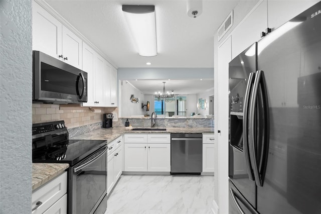 kitchen with tasteful backsplash, visible vents, marble finish floor, black appliances, and a sink