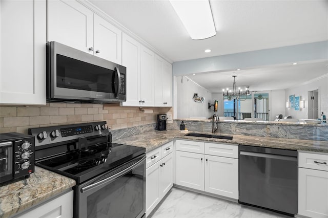 kitchen with marble finish floor, stainless steel appliances, tasteful backsplash, white cabinets, and a sink