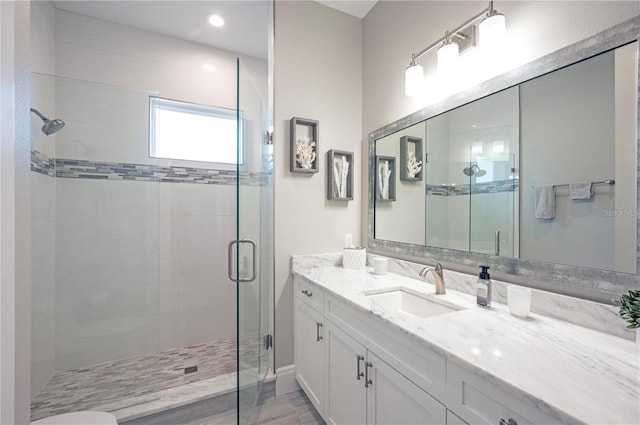 bathroom featuring a stall shower and vanity