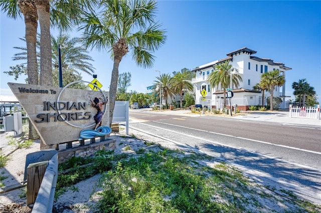 view of street featuring traffic signs, curbs, and sidewalks