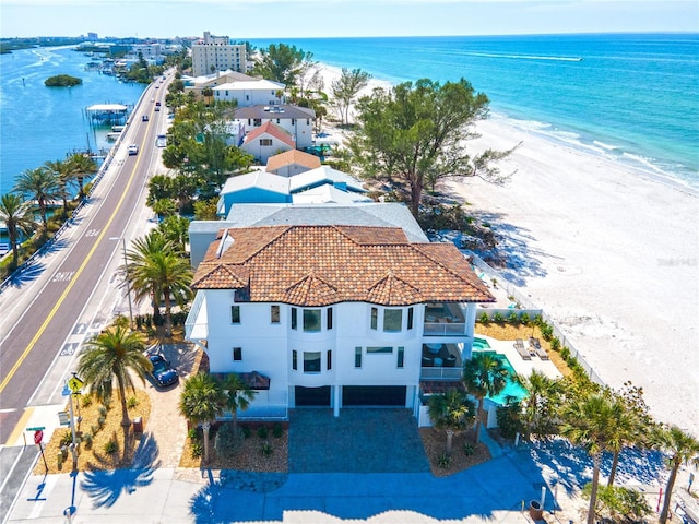 birds eye view of property with a water view and a view of the beach