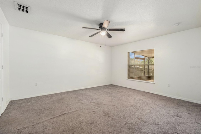 spare room with visible vents, a textured ceiling, and carpet flooring