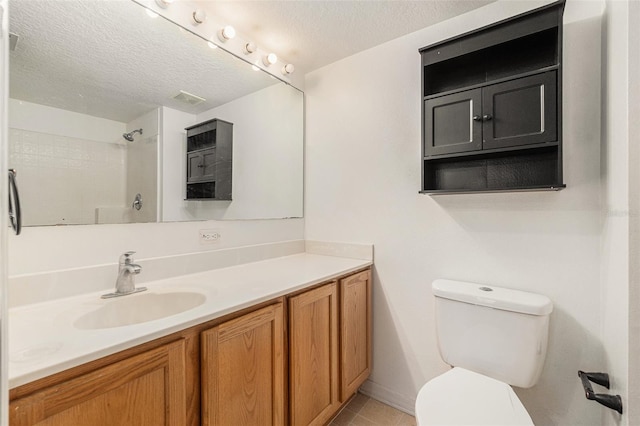 full bath with toilet, tile patterned flooring, walk in shower, a textured ceiling, and vanity