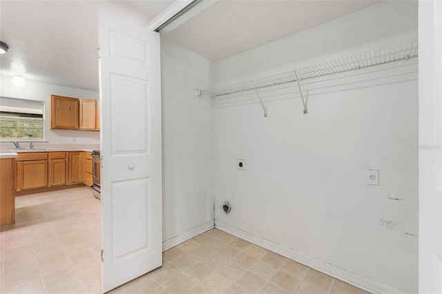 laundry room featuring a sink, laundry area, and hookup for an electric dryer