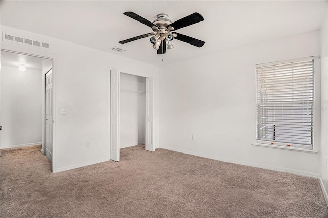 unfurnished bedroom with carpet floors, a closet, and visible vents