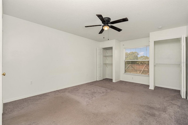 unfurnished bedroom with carpet floors, baseboards, and a textured ceiling