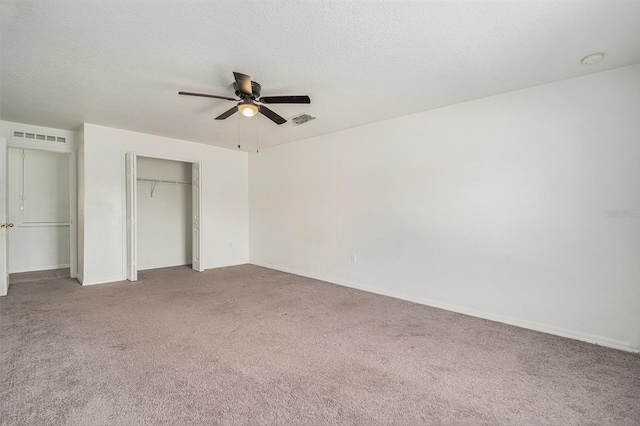 unfurnished bedroom with carpet, a closet, visible vents, and a textured ceiling