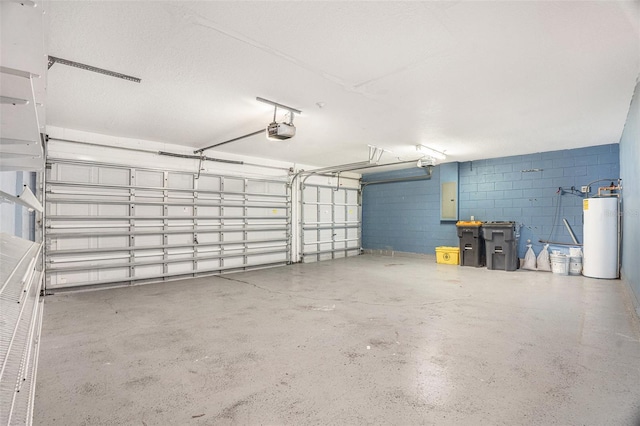 garage with a garage door opener, concrete block wall, and water heater