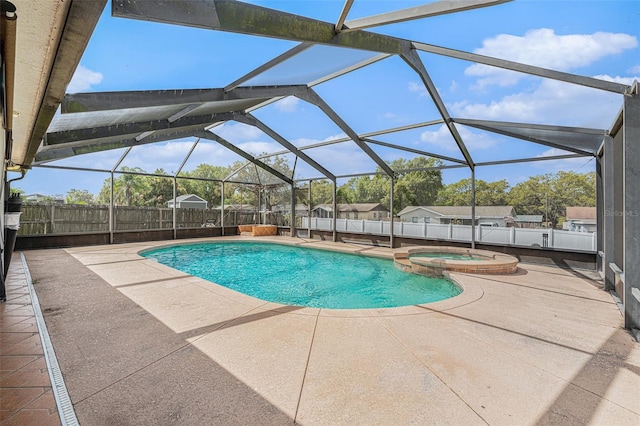 view of swimming pool featuring a lanai, a patio area, a fenced backyard, and a pool with connected hot tub