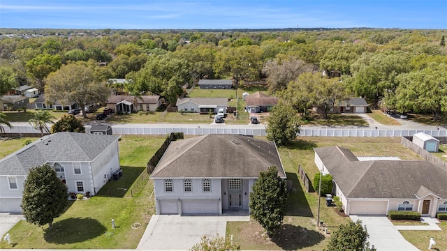 birds eye view of property with a wooded view and a residential view