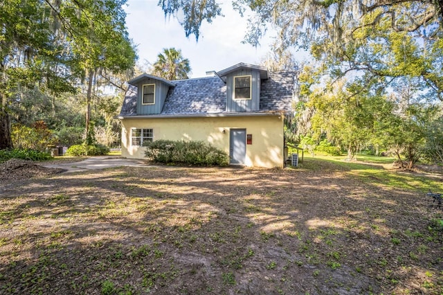 rear view of house with stucco siding