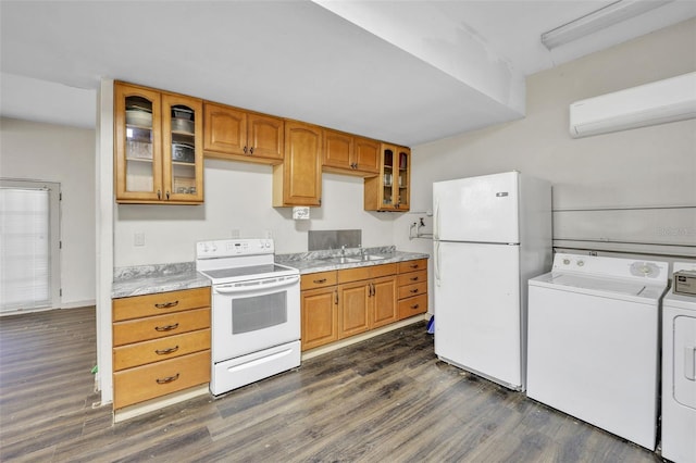 kitchen with washing machine and dryer, white appliances, a sink, light countertops, and dark wood finished floors