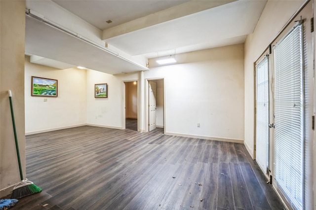 interior space with baseboards and wood finished floors