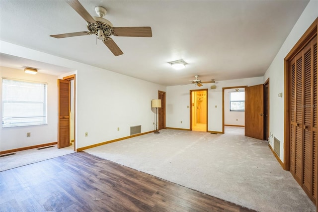 unfurnished bedroom featuring light wood finished floors, visible vents, and baseboards