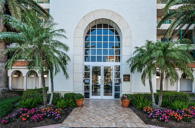 property entrance with french doors and stucco siding