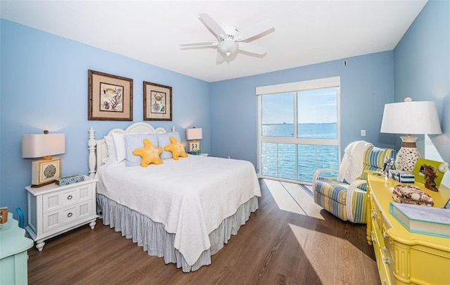 bedroom with dark wood-type flooring, a ceiling fan, and access to exterior