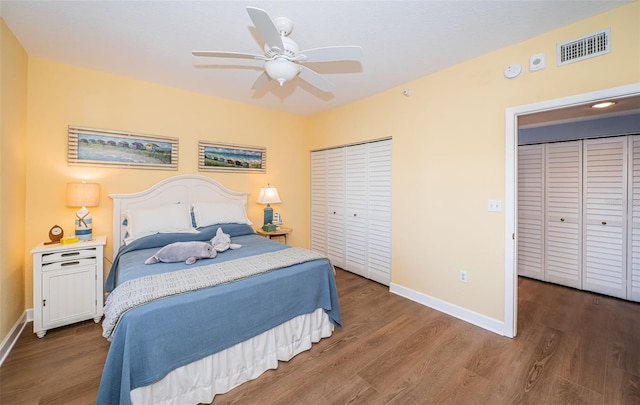 bedroom featuring wood finished floors, visible vents, and baseboards