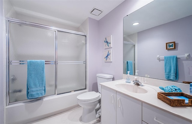 full bath featuring visible vents, toilet, tile patterned floors, combined bath / shower with glass door, and vanity