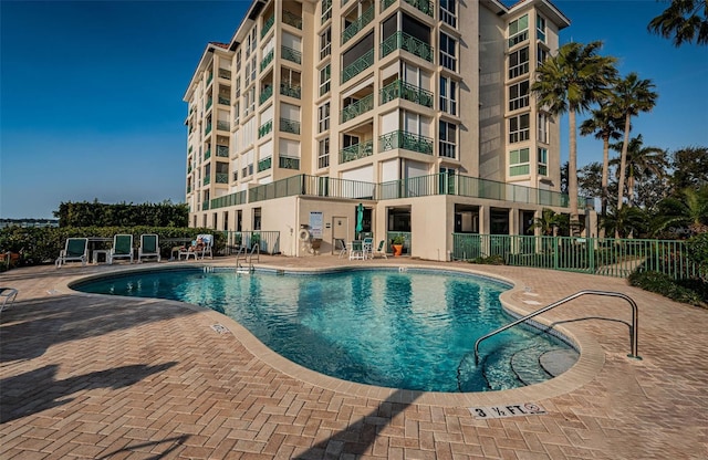 pool featuring a patio area and fence