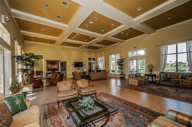 living room with coffered ceiling, beamed ceiling, visible vents, and a high ceiling