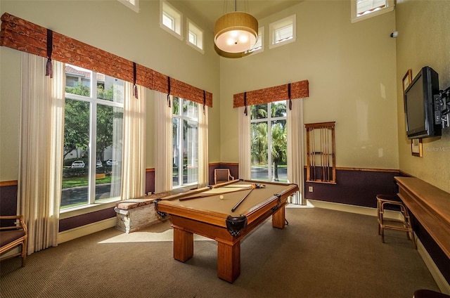 recreation room featuring carpet floors, billiards, a towering ceiling, and baseboards