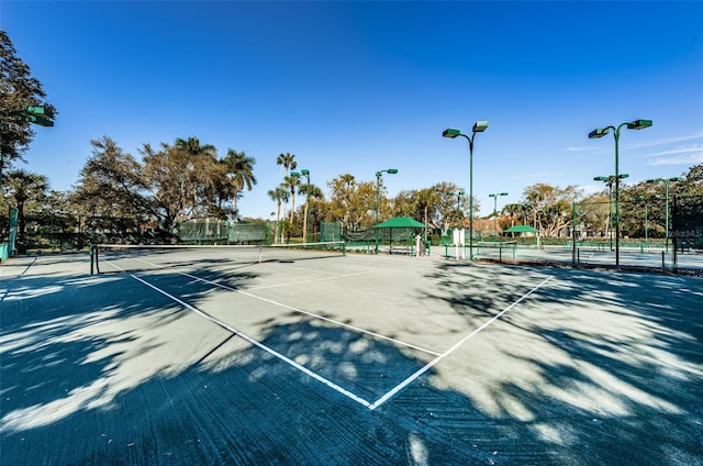 view of tennis court featuring fence