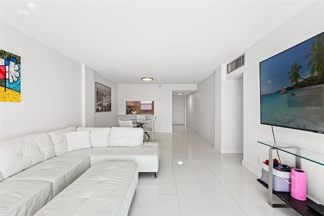 living area featuring visible vents, baseboards, and light tile patterned floors