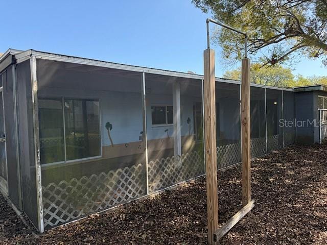 rear view of property with a sunroom