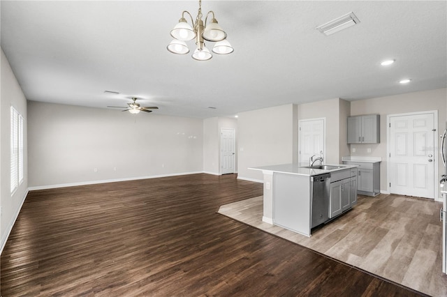 kitchen with visible vents, dishwasher, light countertops, gray cabinetry, and a sink