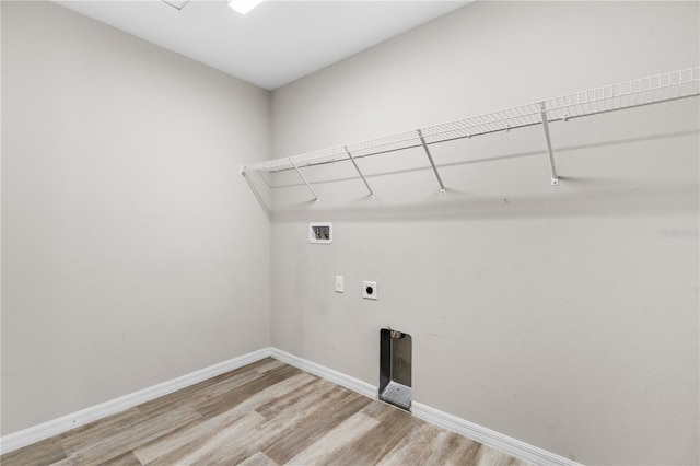 clothes washing area featuring washer hookup, hookup for an electric dryer, light wood-type flooring, laundry area, and baseboards