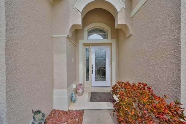 entrance to property with stucco siding