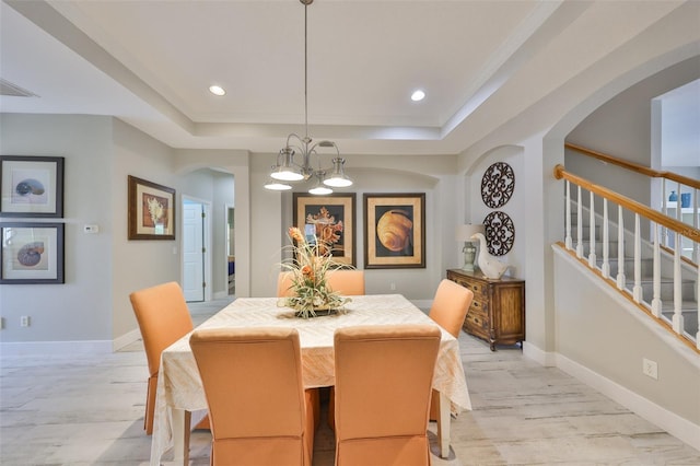 dining area featuring a tray ceiling, recessed lighting, stairway, light wood-style floors, and baseboards