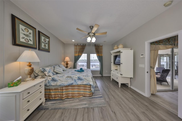 bedroom with light wood-style floors, baseboards, and a ceiling fan