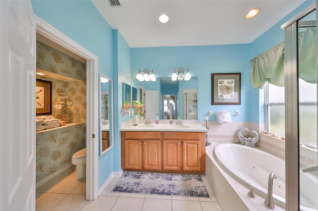 bathroom featuring a jetted tub, tile patterned flooring, a sink, and wallpapered walls